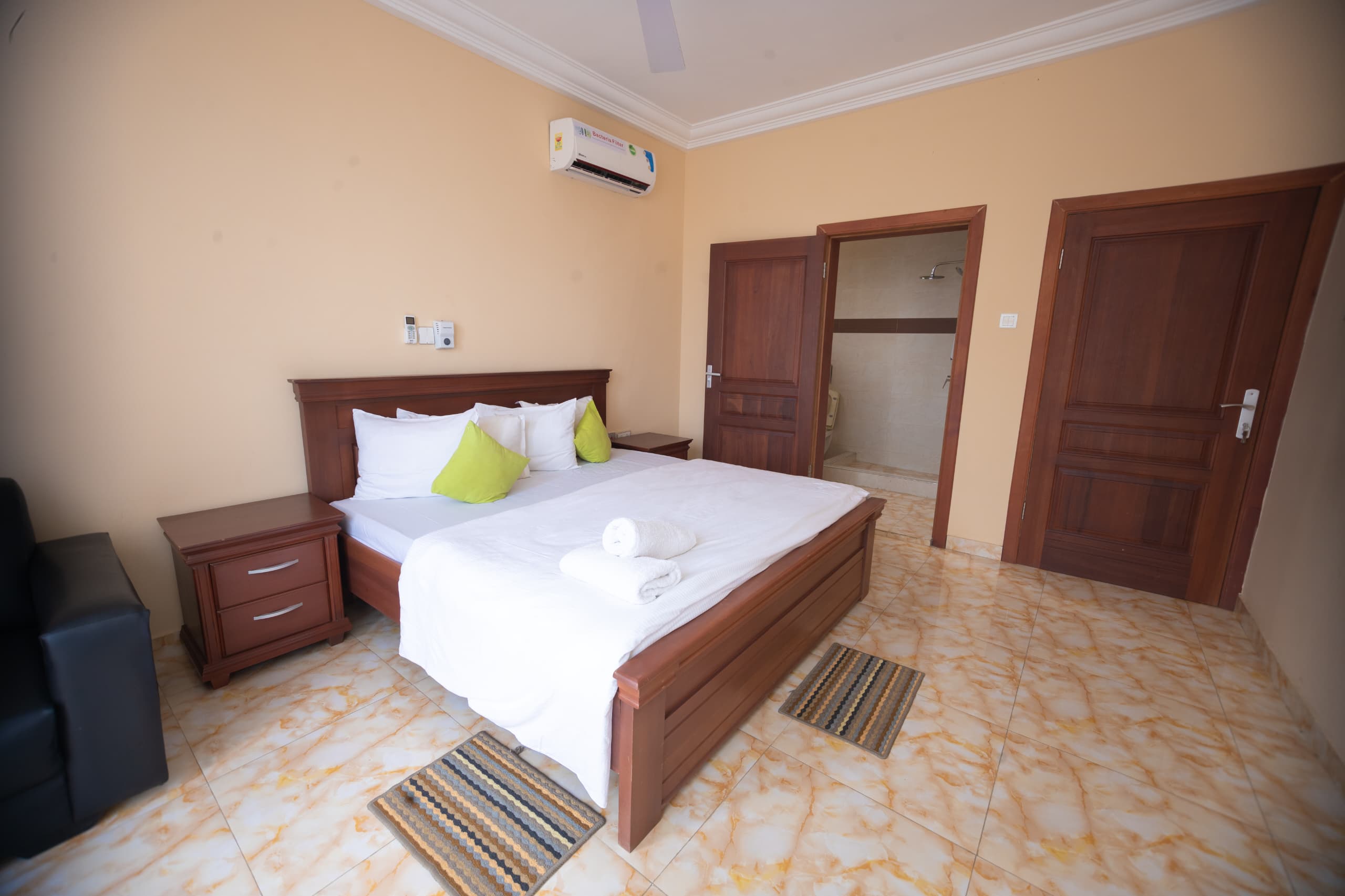 Bedroom with dark wood bed and warm accents