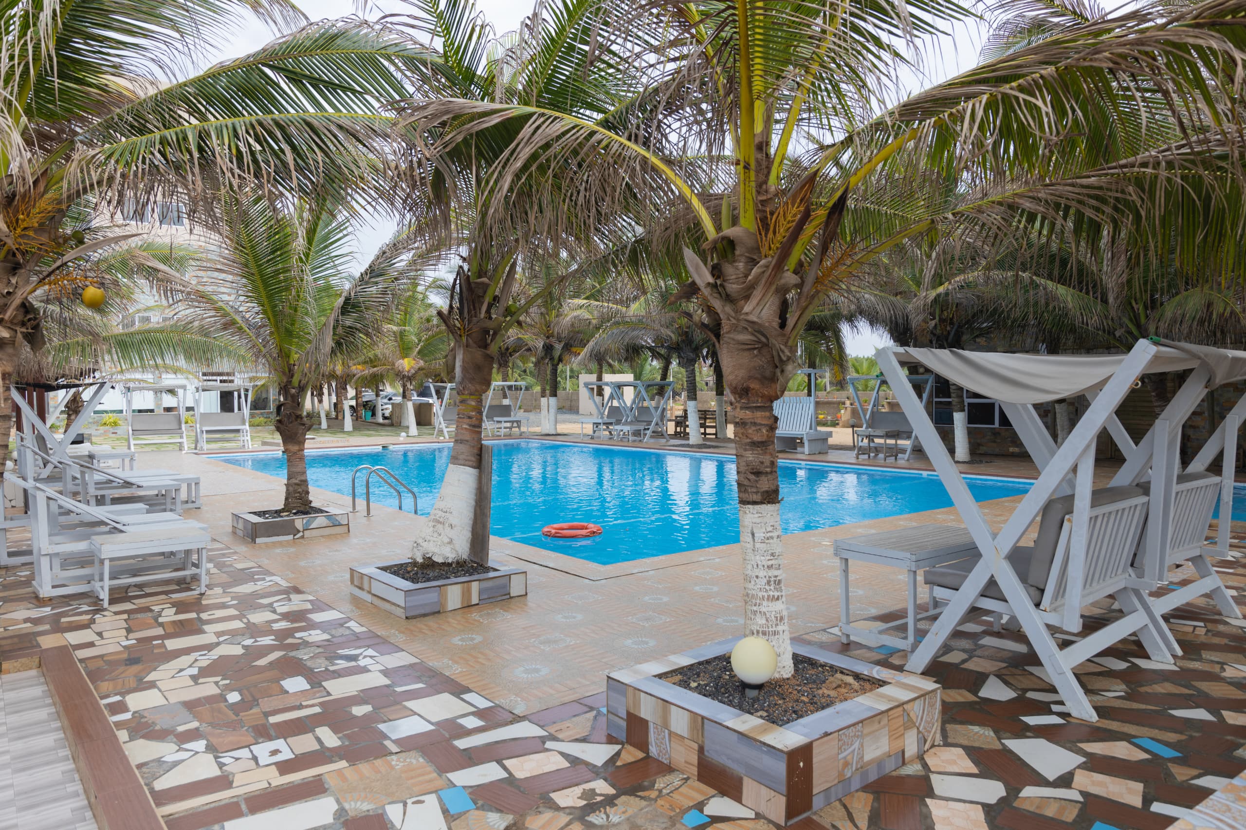 Resort pool area with tropical palm trees