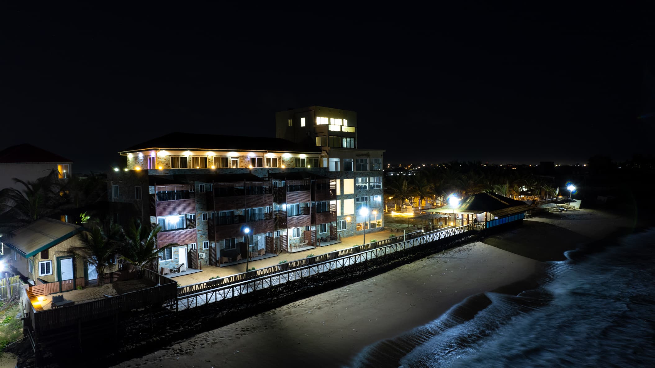 Resort illuminated at night from the beach
